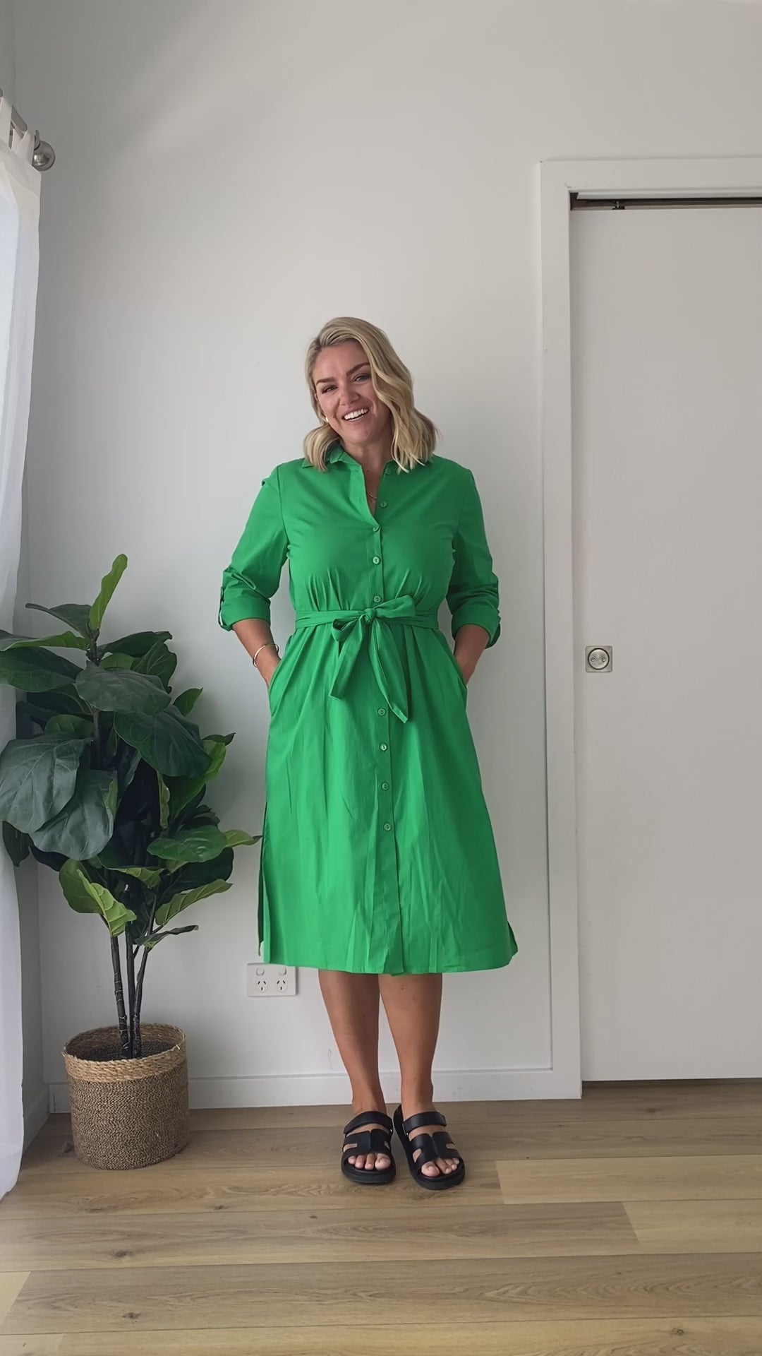 Video of a model wearing a midi length apple green linen shirt dress