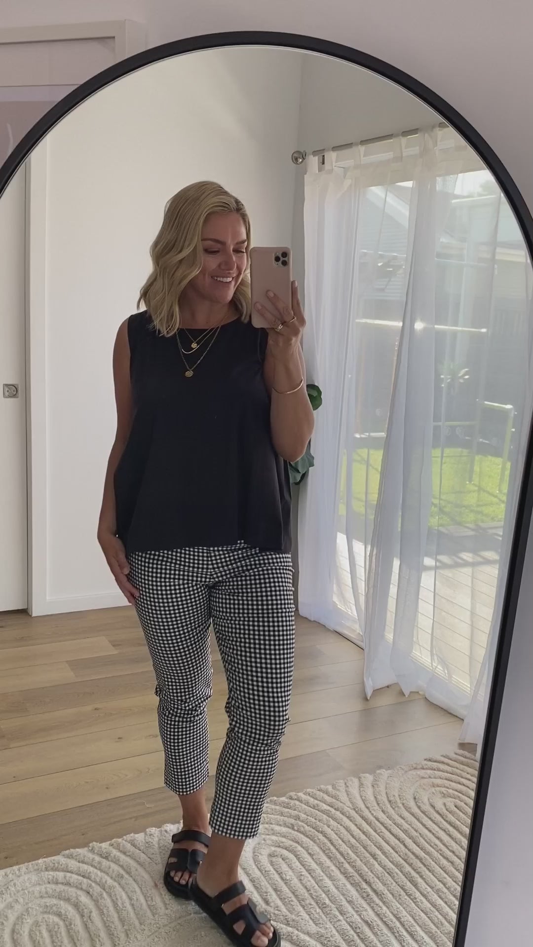 Video with a model showing our black cotton tank with checked bengaline pants